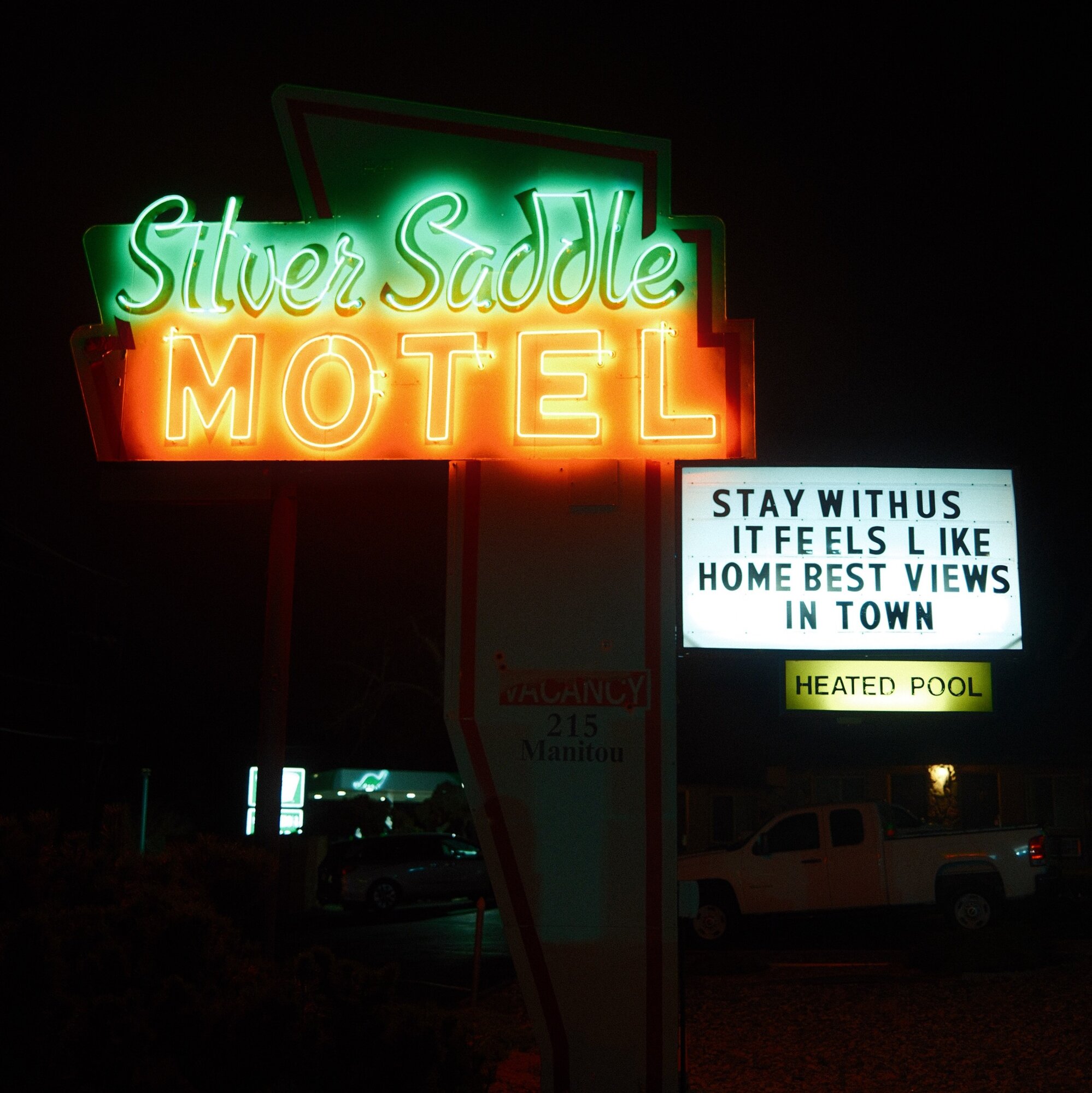 Silver Saddle Motel neon sign glowing green and orange at night